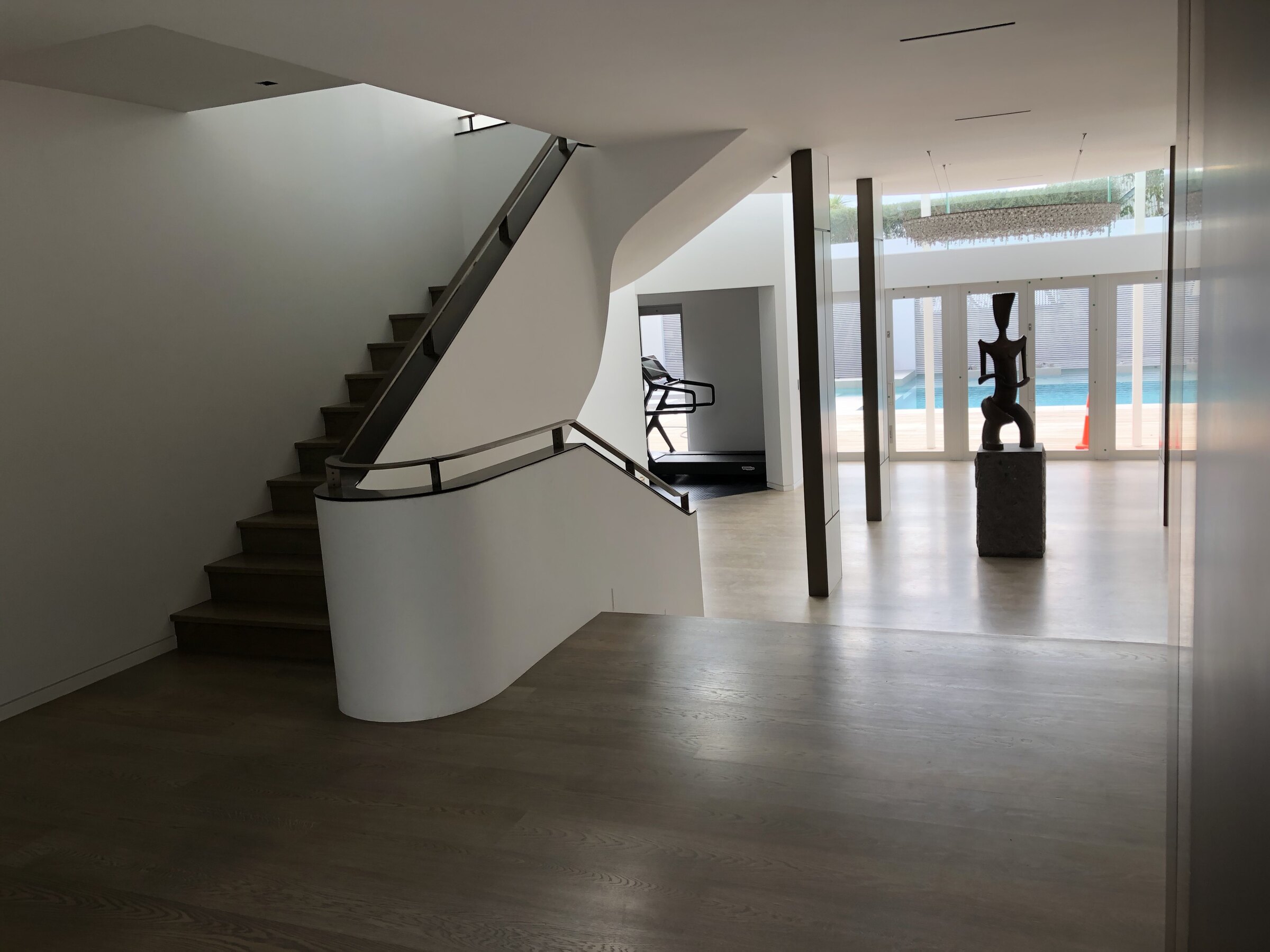 Completed contemporary interior with a curved staircase and clean architectural detailing