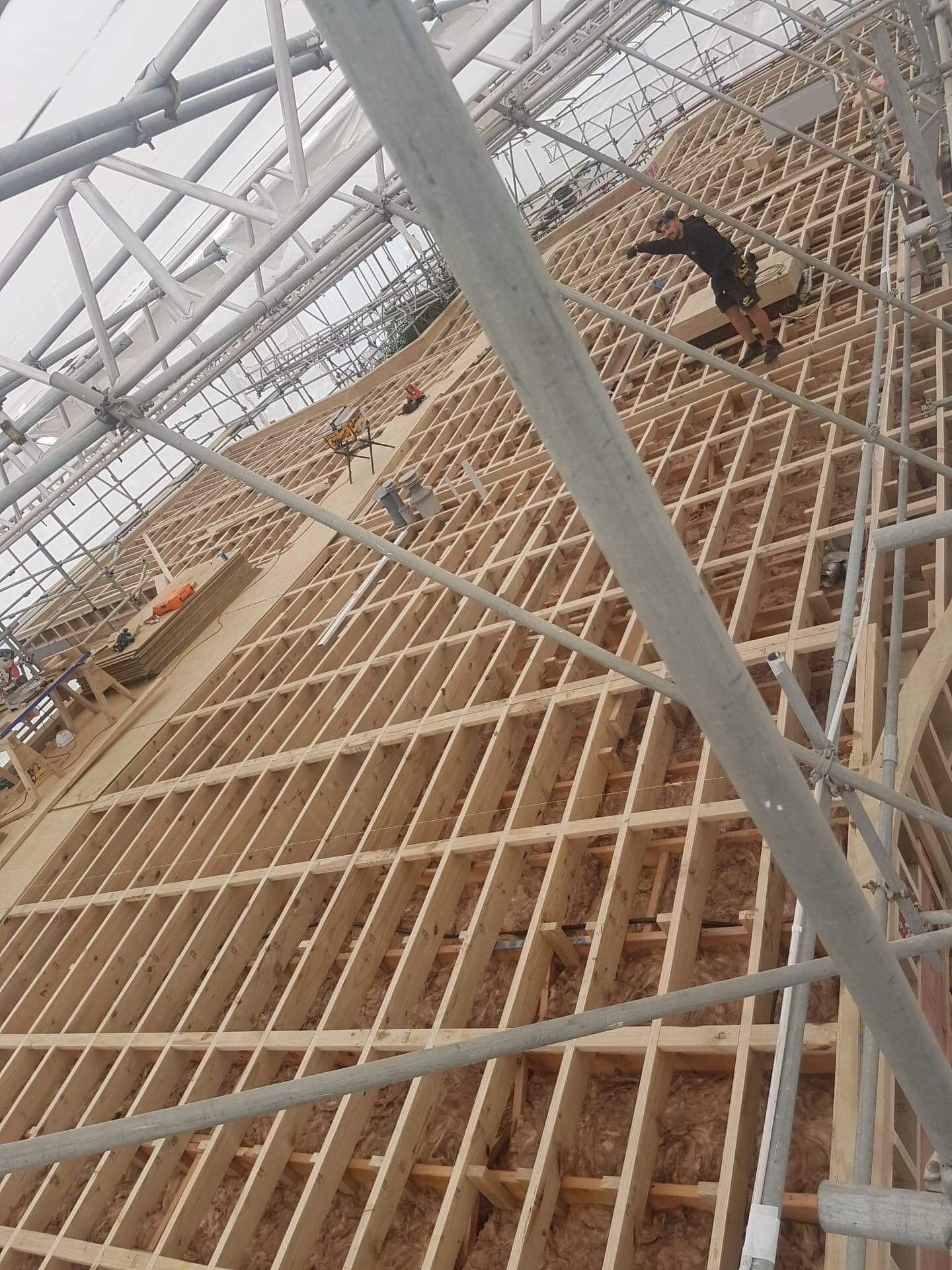 Large-scale timber roof framing under construction