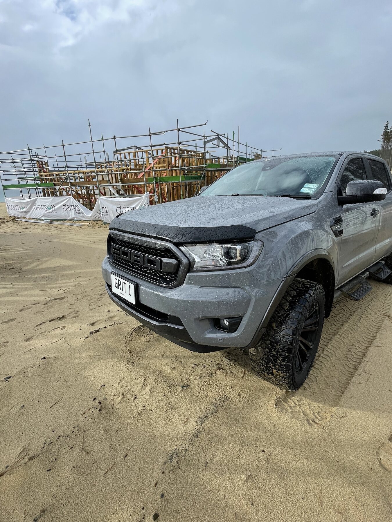 GRIT work vehicle beside a coastal house framing project