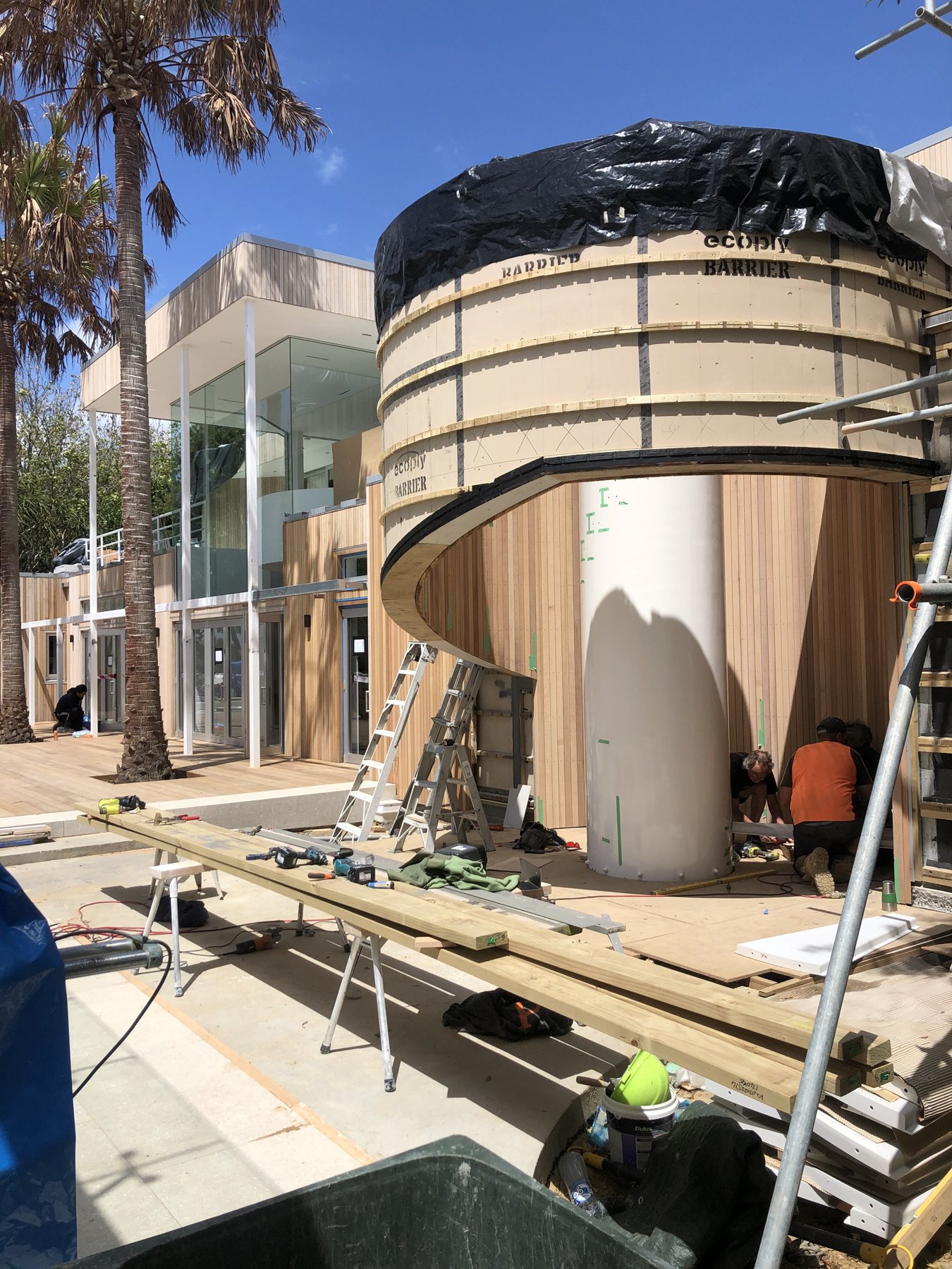 Curved exterior form under construction before cedar cladding