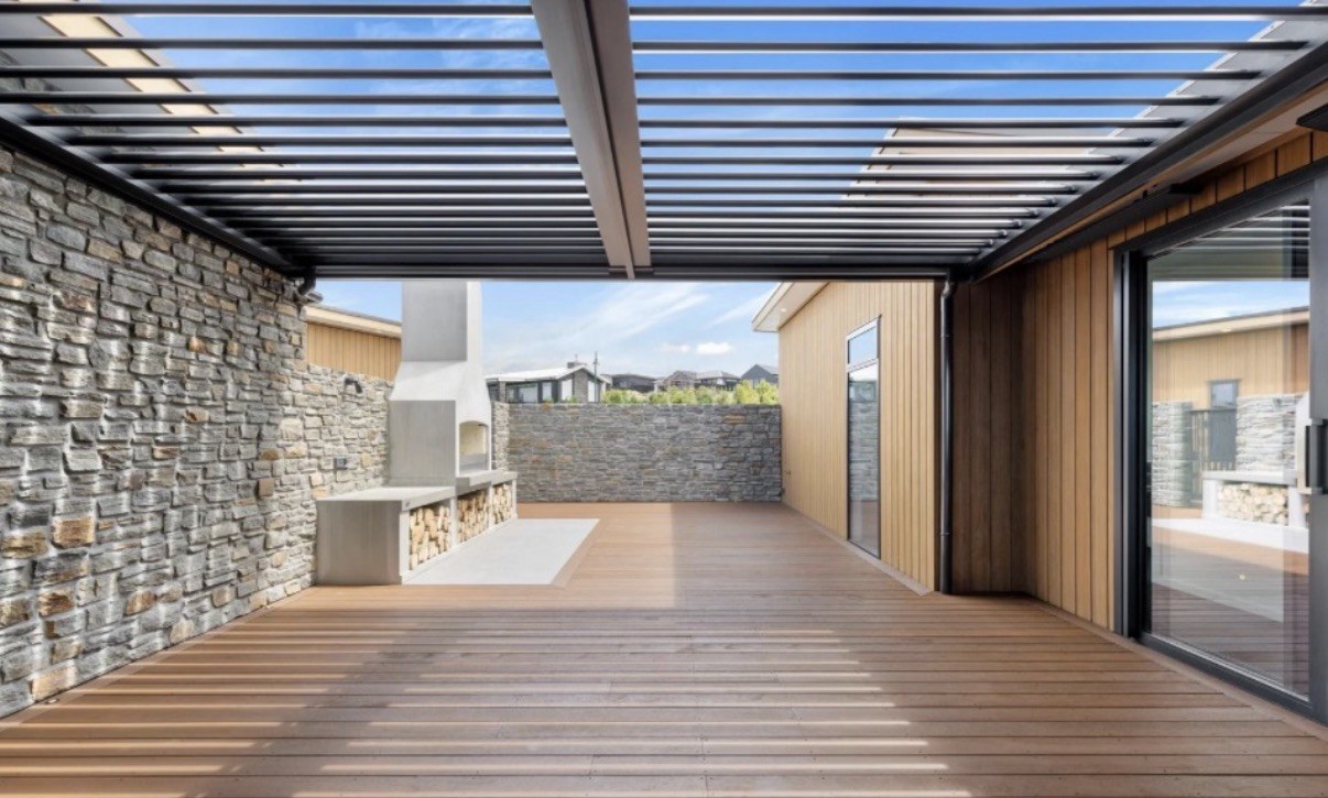 Twin-bay motorised louvred pergola above an outdoor deck at Grey Ghost Lane, Taupō